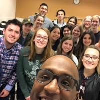 Marvis Herring takes a selfie with students of COM 201.10 in Winter 2019